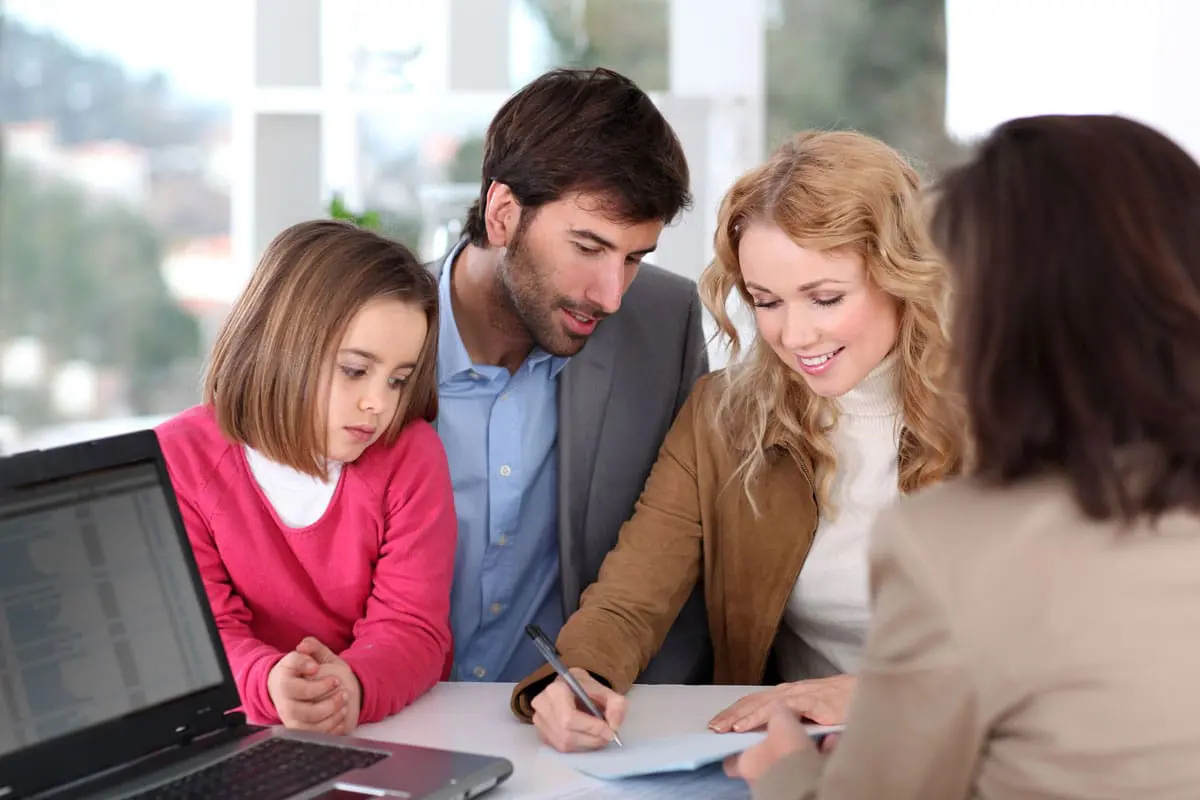 A small family is talking to a credit union employee