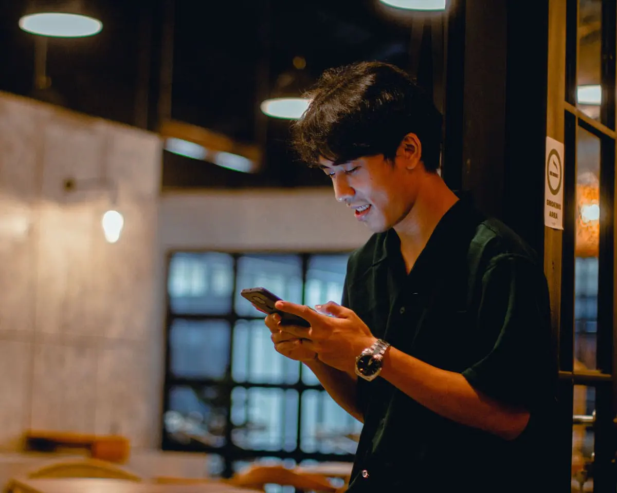 A young man is using his phone