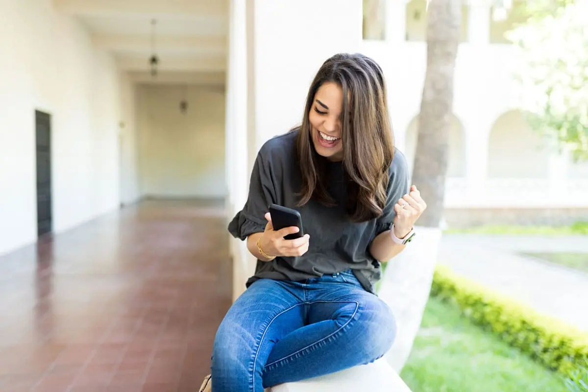 A woman is using her phone to redeem her choice card rewards points