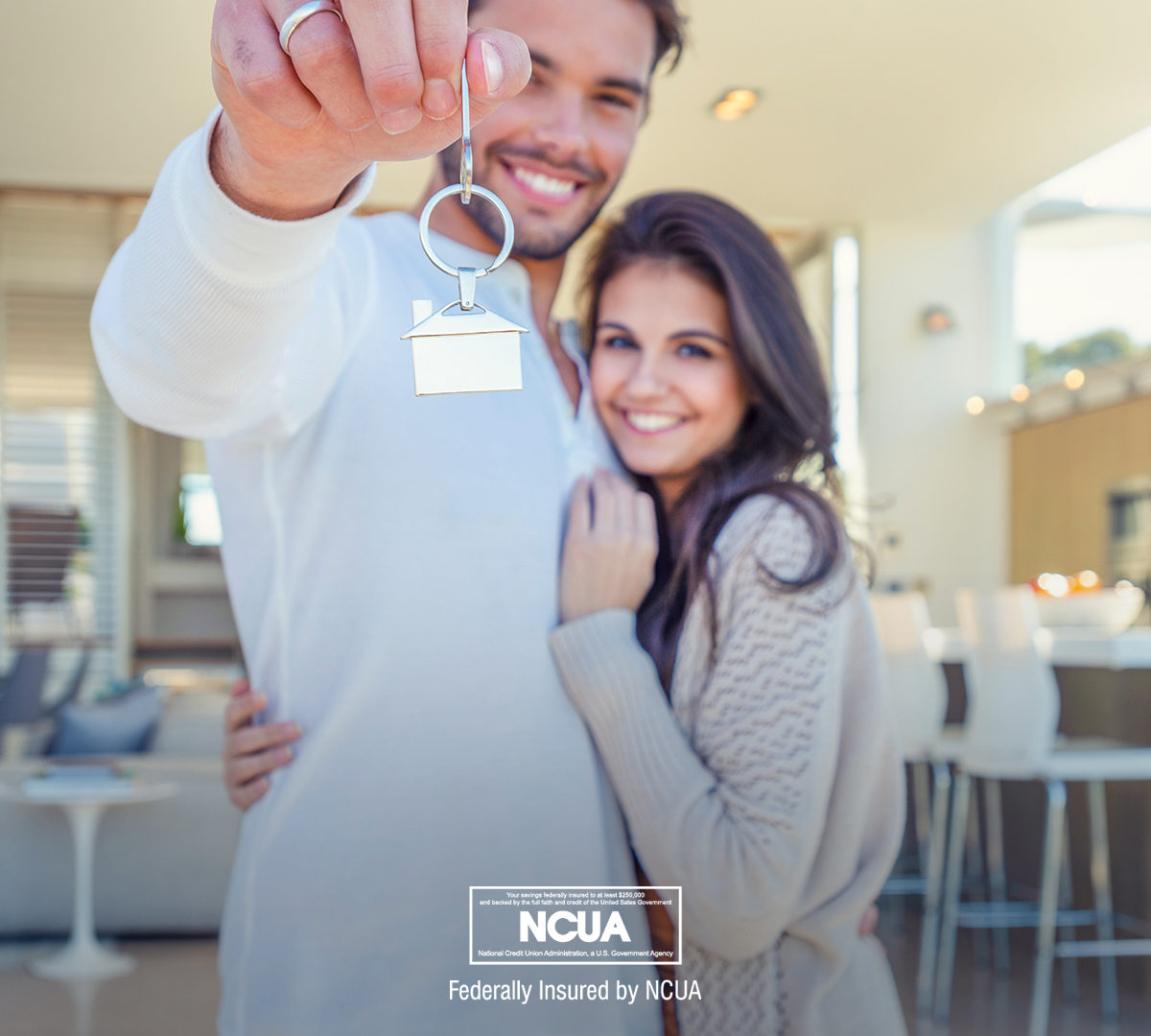 There are many types of home loans in Georgia that offer valuable benefits. In this image, a happy couple are holding the keys to their new home.